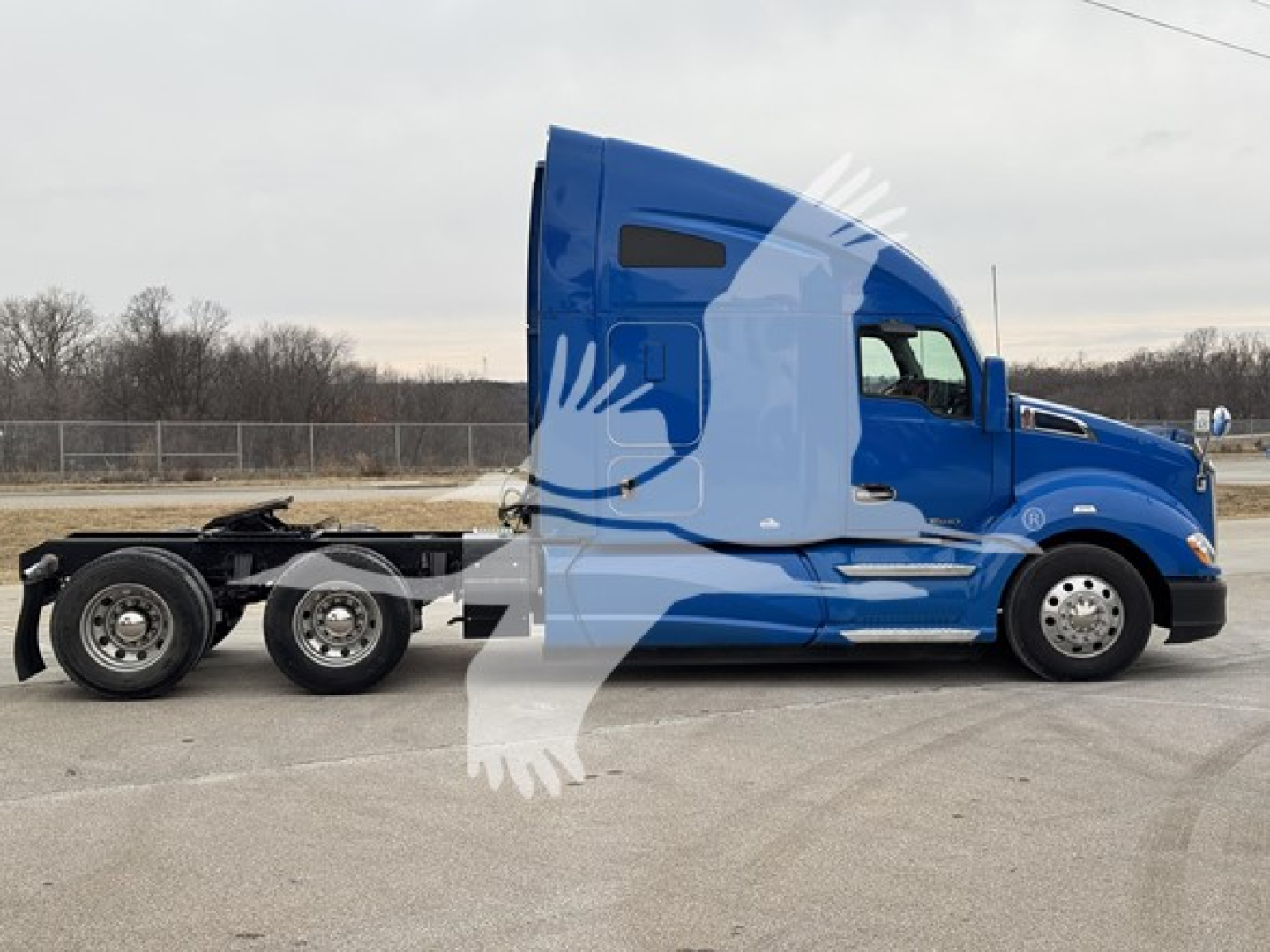 Kenworth T680 truck side view showing blue sleeper cab and chassis with rear axles.