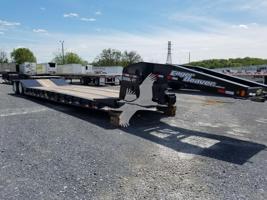 Eager Beaver 35GSL-PT lowboy trailer in open lot showing flatbed with gooseneck and deck, side branding visible.