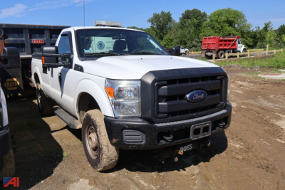 Ford F-250 Super Duty pickup with plow, white crew cab, front view, dirt yard, heavy-duty bumper, plow mount, side mirror extensions.