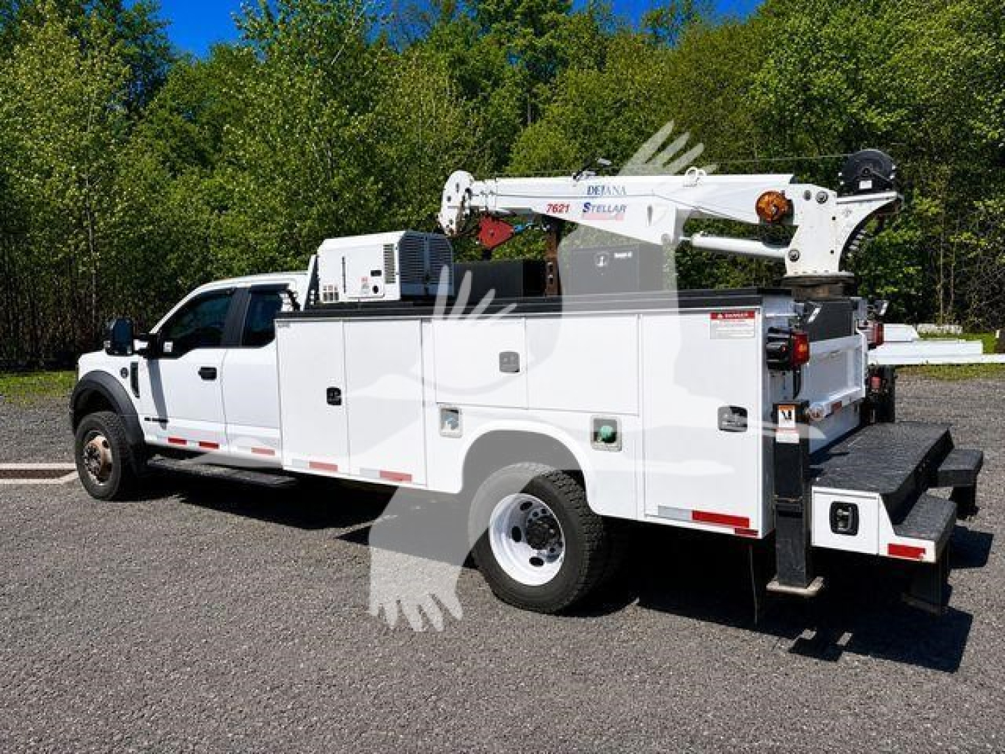 Ford F-550 service/utility truck with crane and multiple compartments, white exterior, stock number T03596, rear view visible.