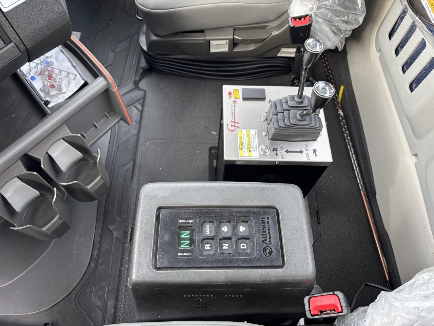 Volvo VHD64B300 cab interior showing gear selector and control panel with labeled buttons and shifter.