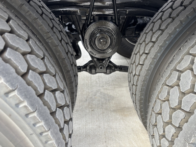 Volvo VHD64B300 rear axle view showing dual rear tires and differential housing along with leaf spring suspension and drivetrain components.