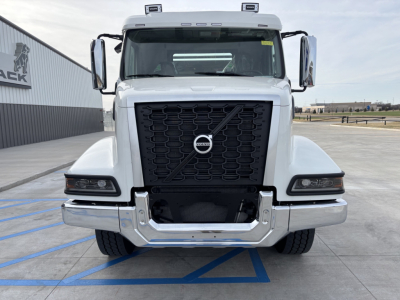 Volvo VHD64B300 roll-off truck front view showing large black grille with Volvo emblem and chrome bumper.