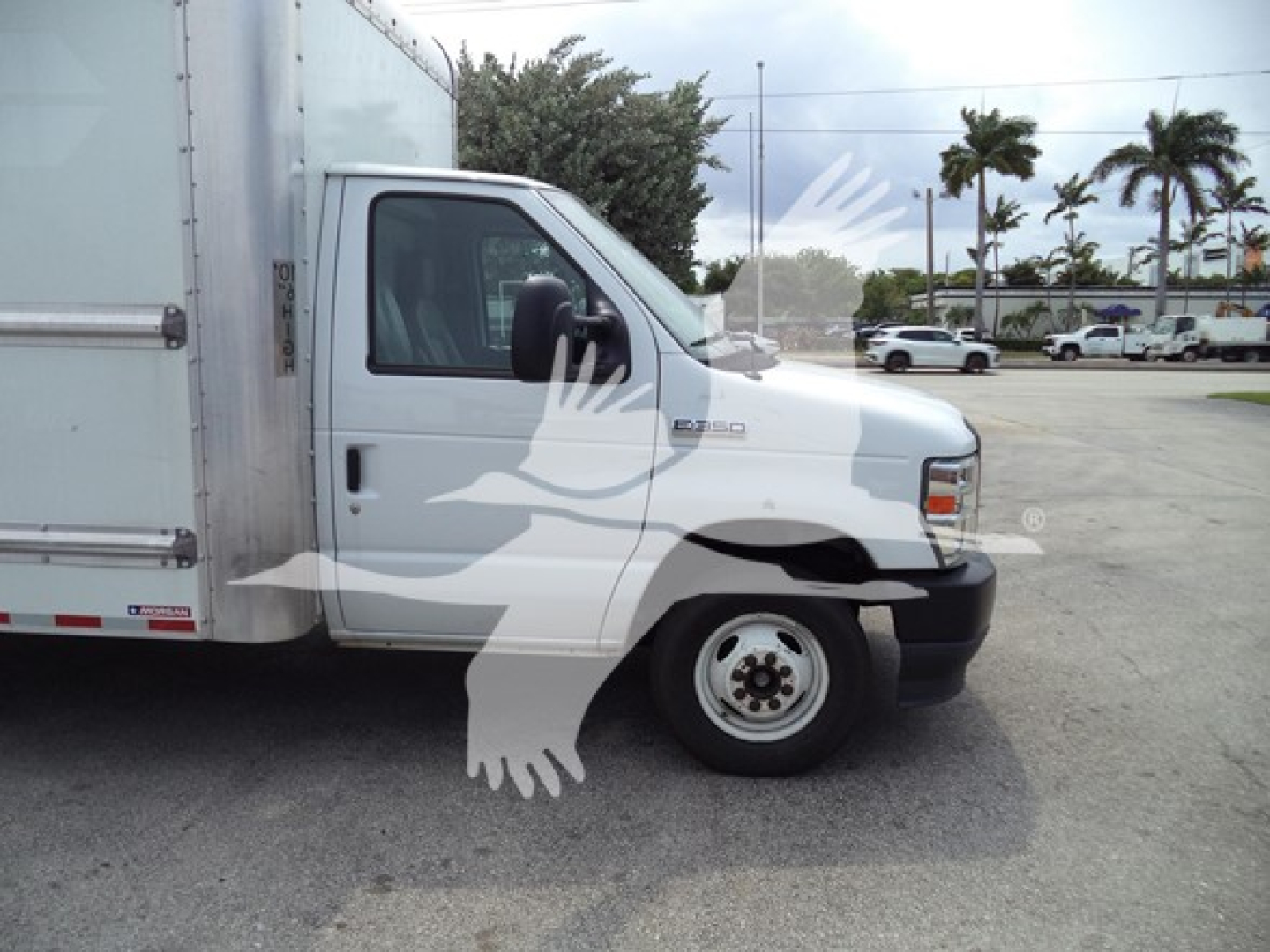 Ford E-350 box truck side view showing cab and cargo box, with no identifying decals visible.