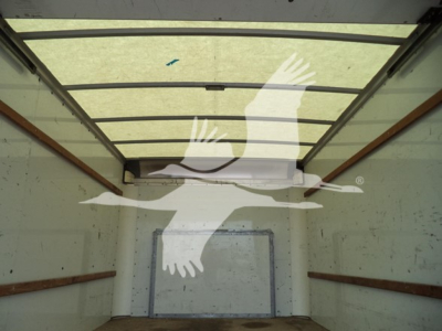 Truck cargo area of a 2022 Ford E350 high roof cargo van showing empty interior with rear doors, no visible damage, light entering from rear.