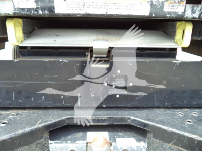 Ford E-350 cutaway rear step with label area and bumper, showing a metal step platform and black body with yellow supports.