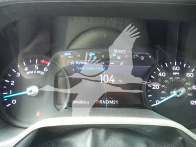 Ford E-350 dash cluster showing speedometer, tachometer, and digital readout with 104°F and gear indicator PRNDM21.