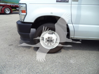 Ford E-350 front wheel well and door area with wheel and tire visible