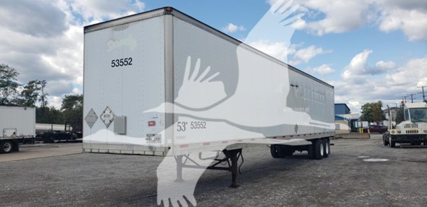 Trailer rear and side view of 2007 Trailmobile dry van with printed numbers 53552 on door and back, white/gray graphics.