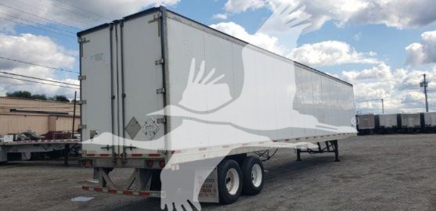 Trailer showing a white 2007 Trailmobile dry van with dual rear wheels and side panels, from rear-right angle.