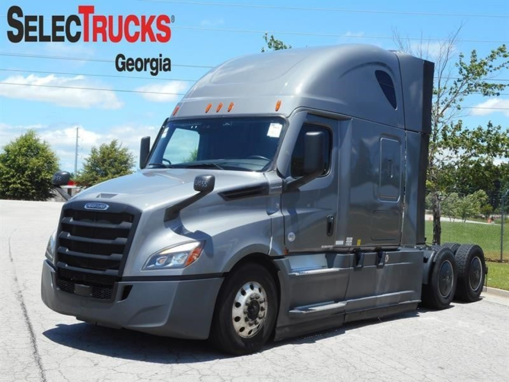 Freightliner Cascadia 126 sleeper cab truck in a dealership lot with Georgia SelectTrucks branding visible.
