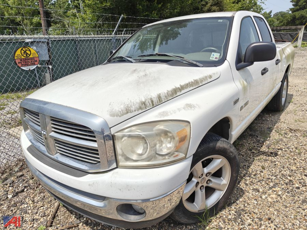 2008 Dodge Ram 1500 Crew Cab pickup truck 4-door 4x2 white with dirt and grime on hood and bumper, front grille with Dodge emblem, alloy wheels, quad headlights, gravel lot.