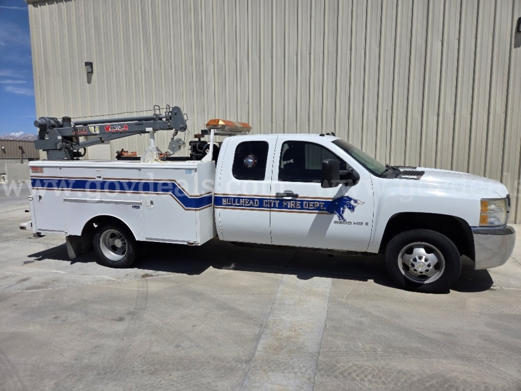 Chevrolet Silverado 3500HD service utility truck side view showing crane equipment and decals