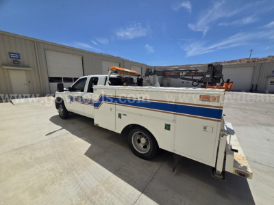 2009 Chevrolet Silverado 3500HD service utility truck with utility bed and crane, side view showing stock number 9764-25 and VIN 1GBJK79619E130307.
