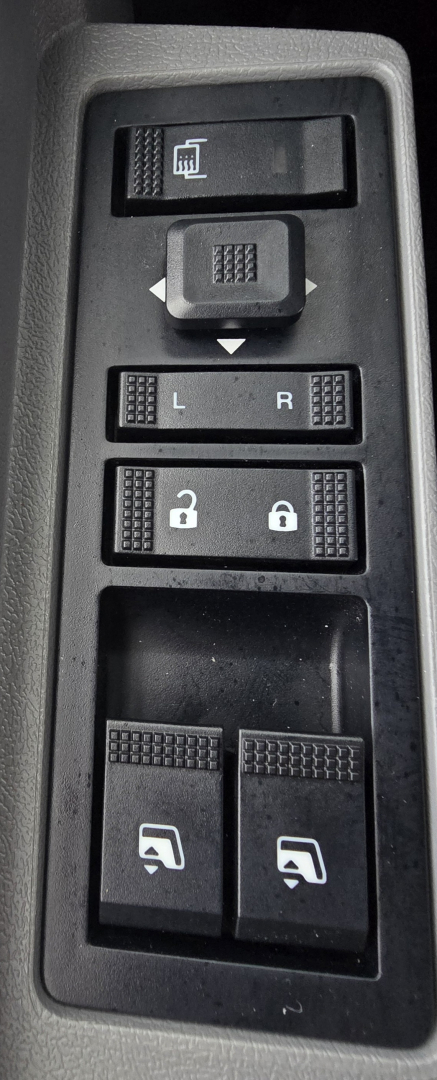 Mack PI64T control panel showing window lock switch, mirror adjust controls, and door/window lock buttons.