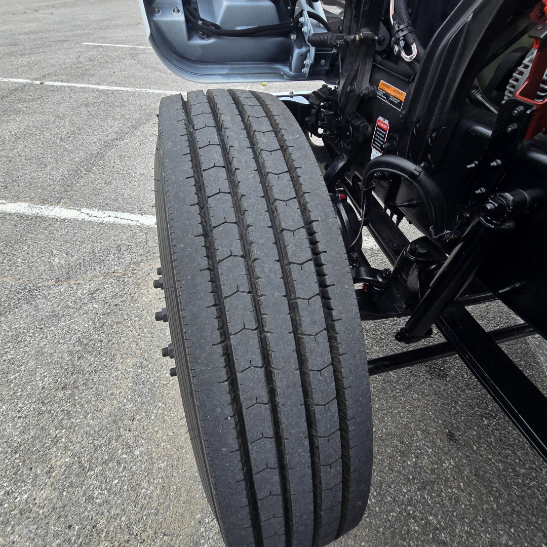 Front dual rear-wheel setup of a 2027 Mack PI64T daycab truck showing tire tread and suspension components.