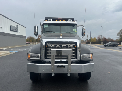 Mack GR84F dump truck front view showing large grille, bumper, and Mack emblem; headlights, mirrors, and winch plate visible.