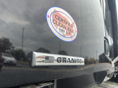 Mack GR84F truck rear/side showing Granite badge and Certified Clean Idle sticker visible on dark exterior.