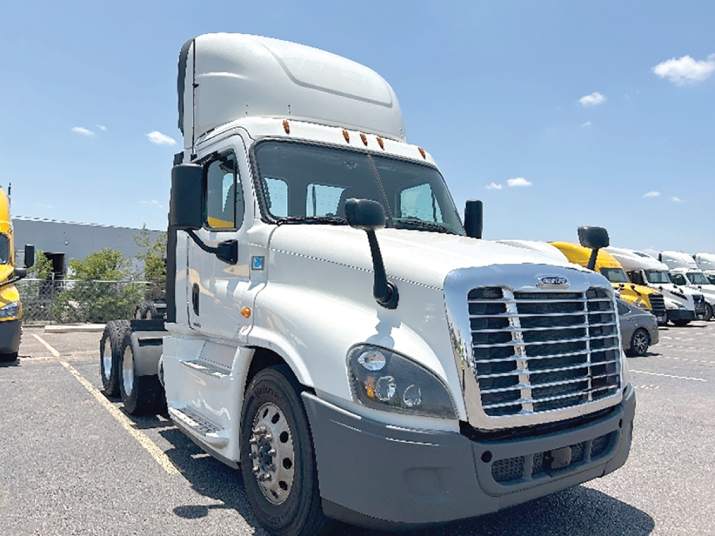 Truck undercarriage cab view of a 2019 Freightliner Cascadia Evolution in a dealership lot showing front grille, headlights, and side mirrors.