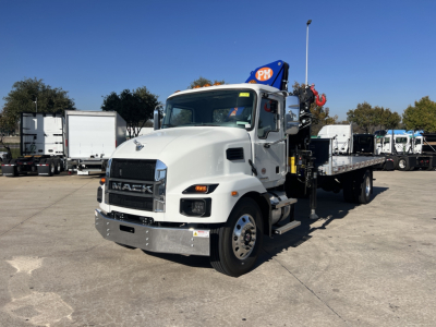 White 2025 Mack MD7 boom truck with crane mounted on flatbed, front grille displays MACK, VIN sticker not visible, no text readable on equipment aside from truck branding.
