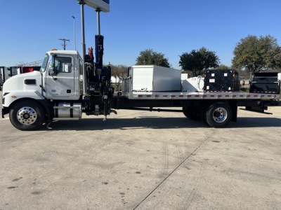 Truck cab and flatbed w/ crane boom on a 2025 Mack MD7 in-service. VIN 1M2MDBAB4SS077295 visible with stock number 67581.