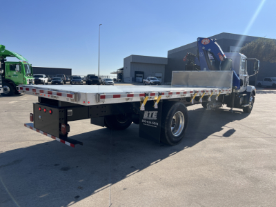 Flatbed tow truck with a chrome flatbed and a mounted crane at the rear. Visible text includes BTE on the mudflap and the rear light housing.