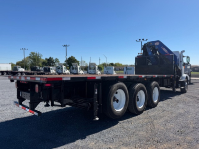 Flatbed truck with crane on a tri-axle chassis and blue crane mounted at rear, Volvo VHD 2006 used category trucks.