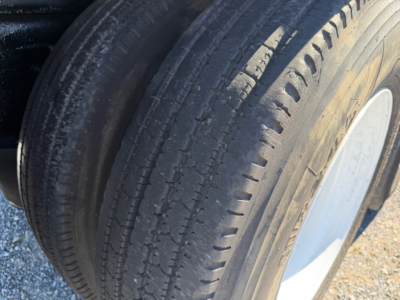 Volvo VHD crane truck wheel showing tire tread and wheel rim.