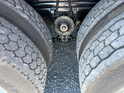 Volvo VHD truck rear undercarriage showing dual rear tires, drivetrain differential housing, and suspension components in view.