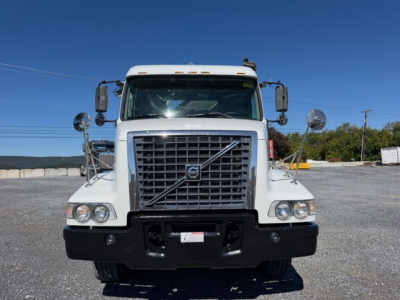  Volvo VHD truck front view showing large grille with Volvo emblem and bumper.