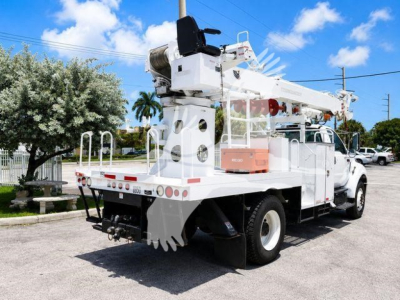 Terex Commander truck crane in-service showing upper boom and outriggers with white and light orange components.