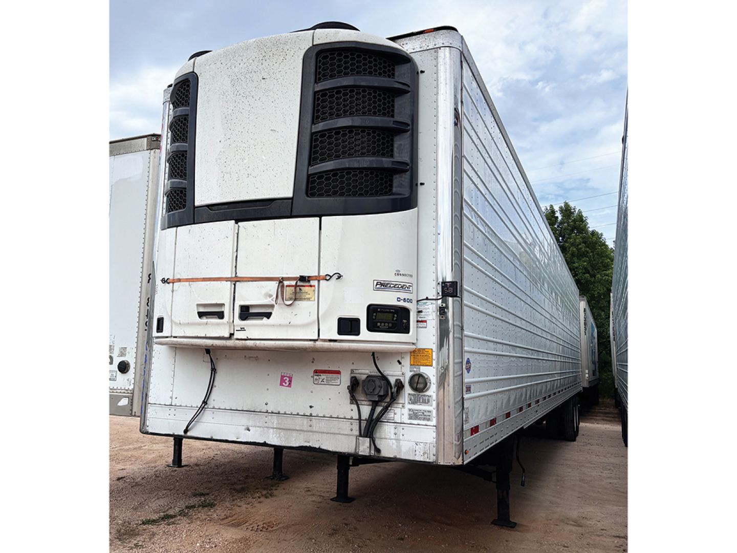 Utility reefer trailer with large front refrigeration unit and white side panels, 2020 Utility 3000R model, front view showing landing gear and coupler area.