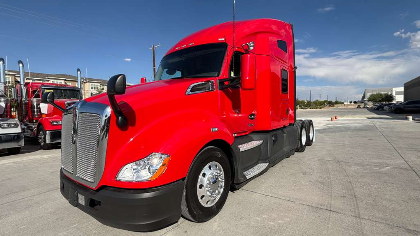 Kenworth T680 tractor in red, front and side view showing sleeper cab, chrome grille, dual fuel tanks, wheels, and aerodynamic mirrors.