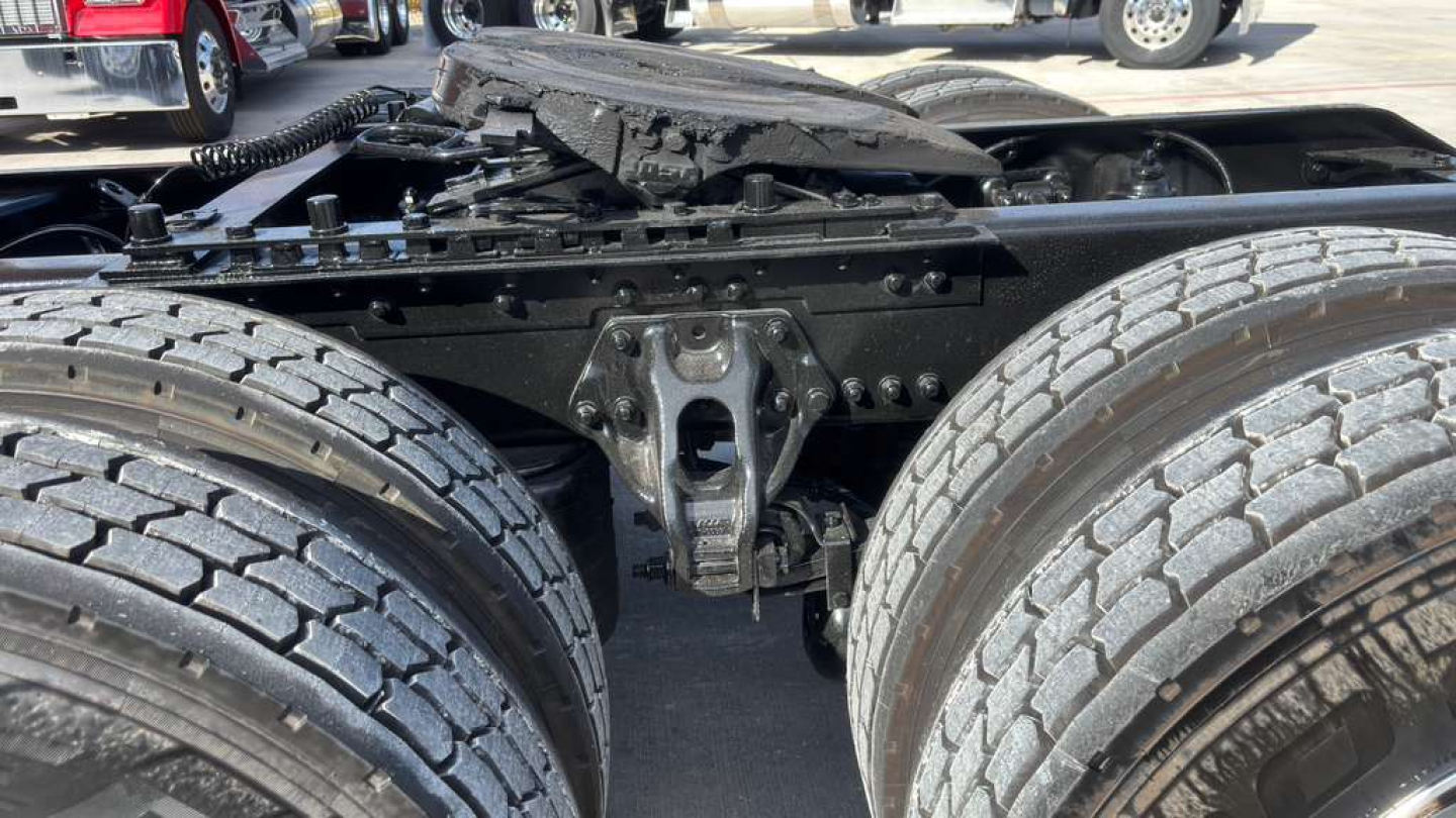 Kenworth T680 truck chassis showing dual rear axles and frame with components and suspension visible.
