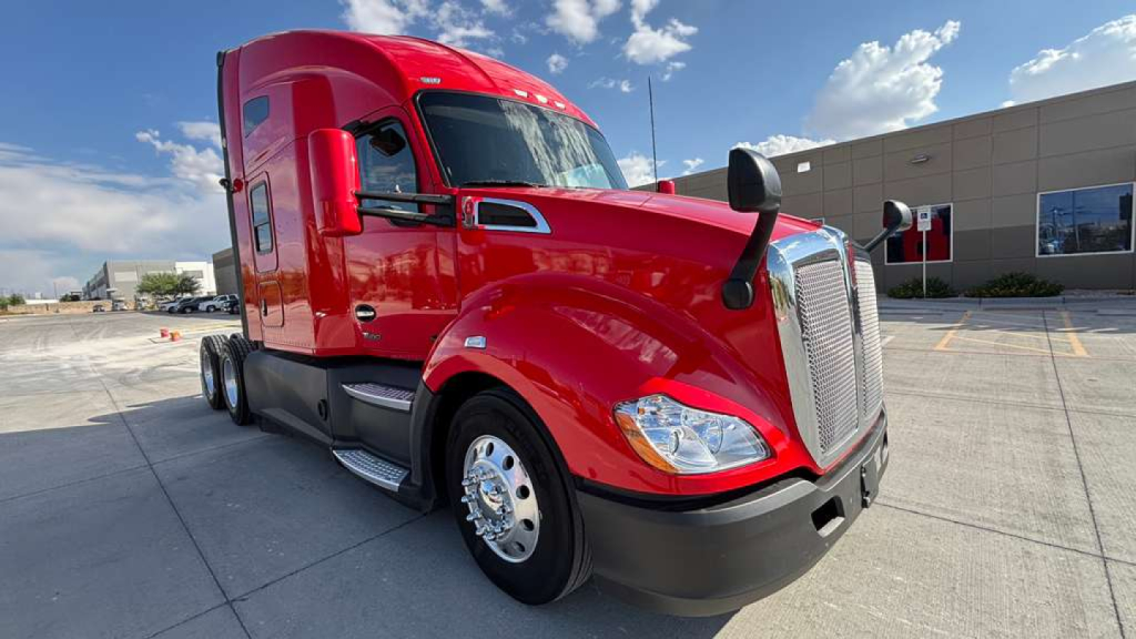 Kenworth T680 truck in red, front three-quarter view showing semi-truck hood, grille, headlight, and side mirrors.