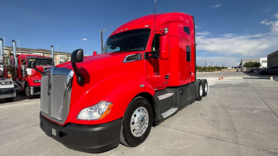 Kenworth T680 tractor in red, front and side view showing sleeper cab, chrome grille, dual fuel tanks, wheels, and aerodynamic mirrors.