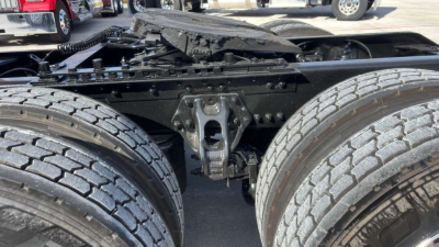 Kenworth T680 truck chassis showing dual rear axles and frame with components and suspension visible.
