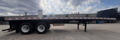 Flatbed trailer showing Fontaine 37' combo with fork lift kit. Dual rear axles, black frame, white wheels, side rails, and landing gear visible.