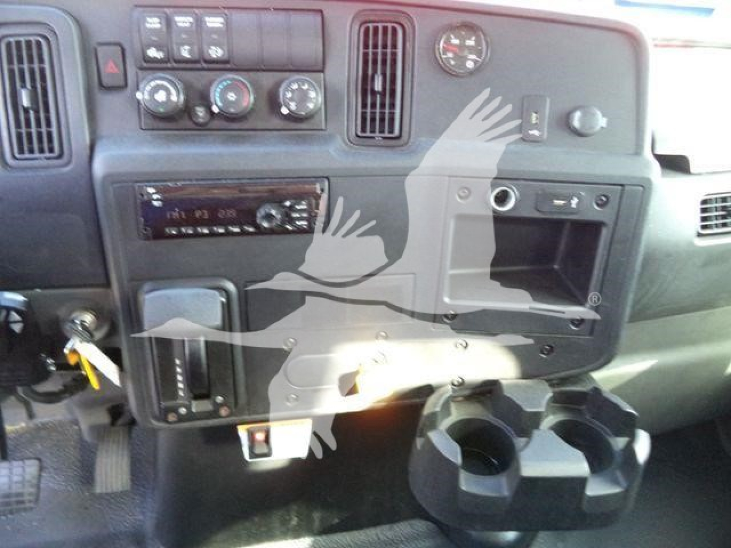 Dashboard of a 2019 International 4300 truck cab showing control cluster, radio, climate controls, and cup holders.