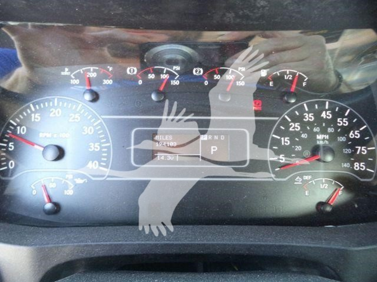 Dashboard of a 2019 International 4300 showing speedometer, tachometer, and various gauges; center display with odometer and gear indicator; faint watermark hands overlay image.