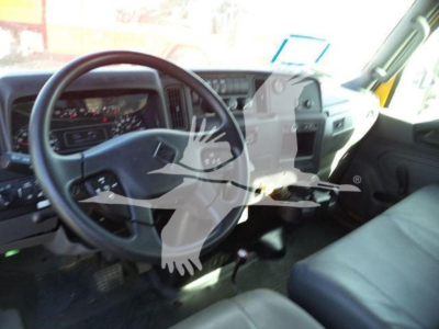 Interior of a 2019 International 4300 cab showing steering wheel, dashboard, and driver seat with some equipment visible.