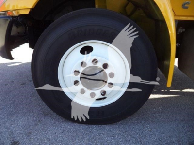 Truck wheel and tire on a 2019 International 4300 chipper body, showing Bridgestone tire and white steel wheel with lug nuts.