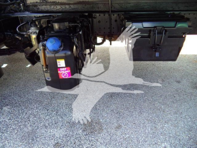 Isuzu NPRR undercarriage showing DEF/blue cap reservoir and battery box with wiring; side view of truck frame and toolbox.