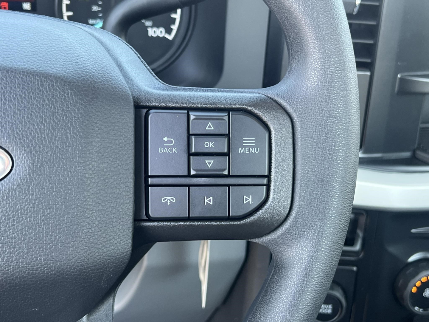 Ford F-450 cab and chassis steering wheel with control buttons shown in close-up