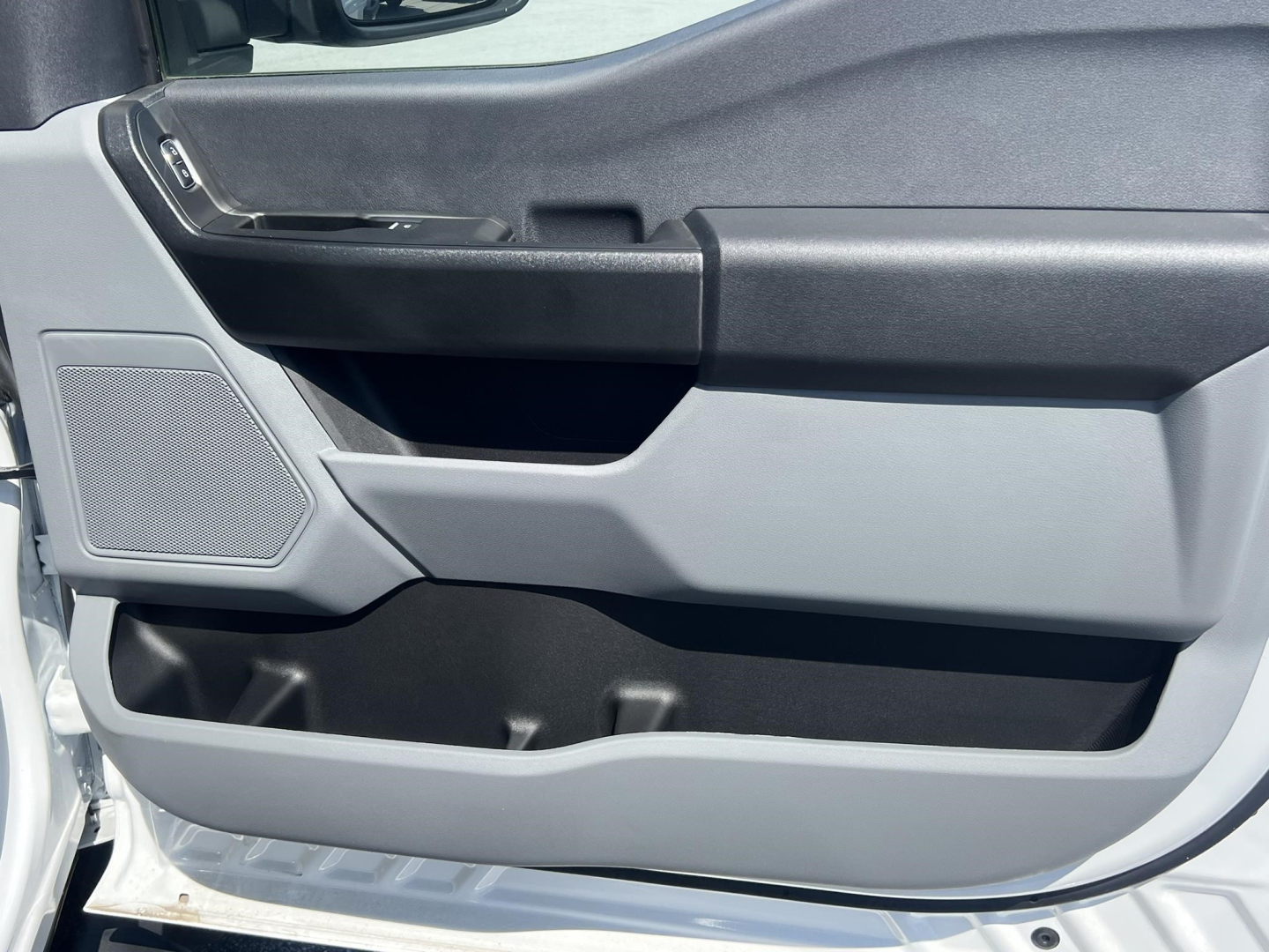 Ford F-450 cab and chassis door interior panel showing storage pocket and speaker grille.