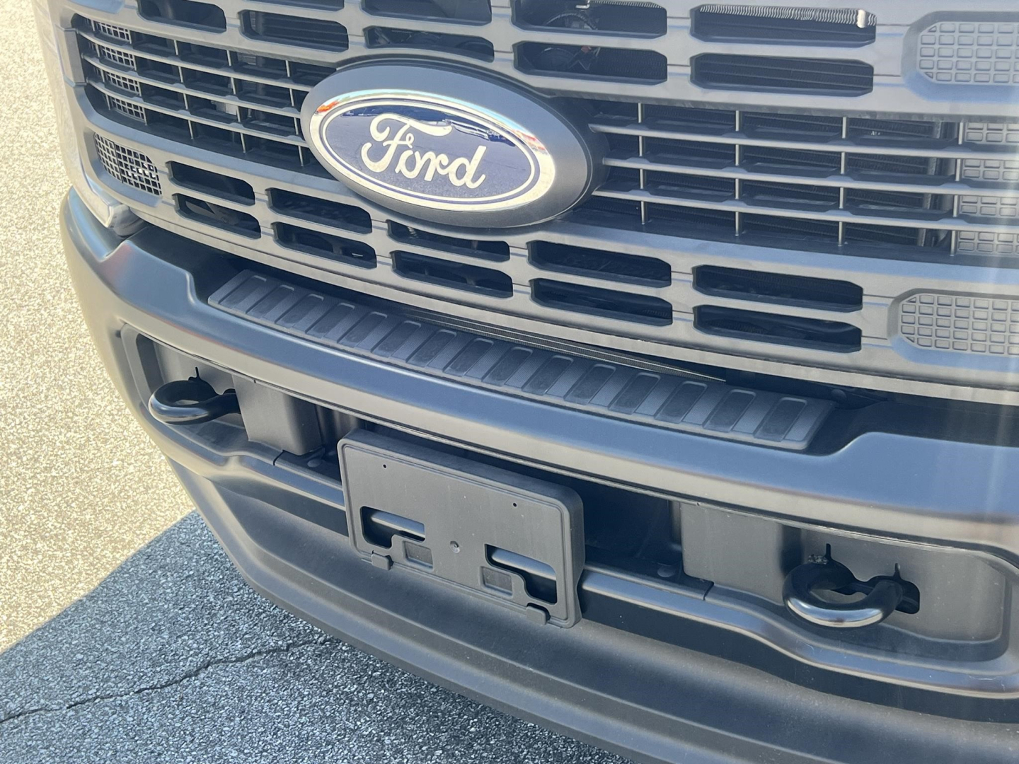 Front view of a Ford F-Series cab and chassis showing Ford emblem and front bumper area.