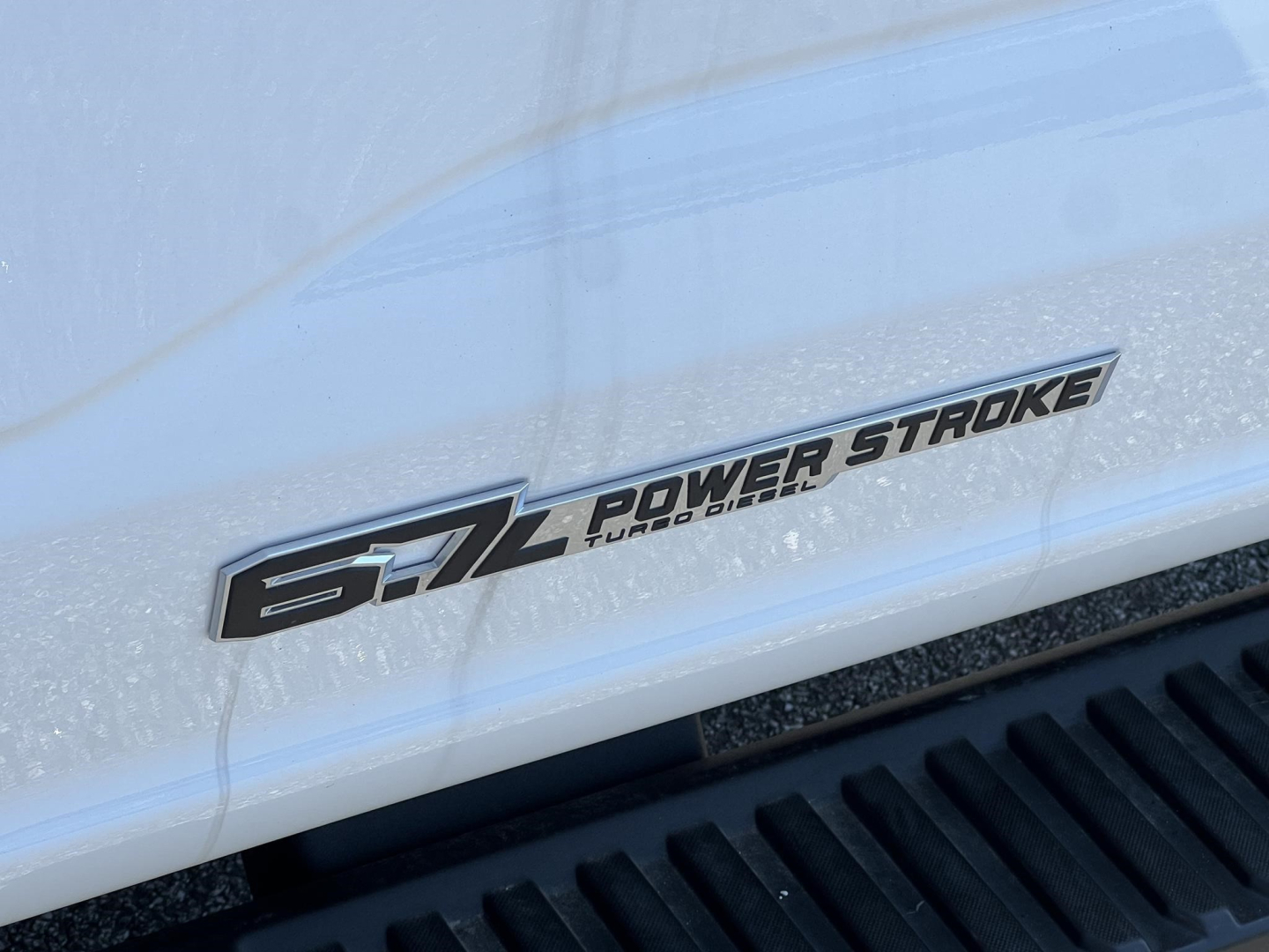 Ford F-450 cab and chassis badge showing Power Stroke Turbo Diesel badge on white body panel.