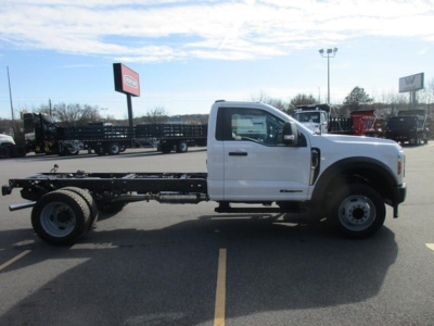 Ford F-450 cab and chassis low side view showing blank chassis frame and single cab with white paint.
