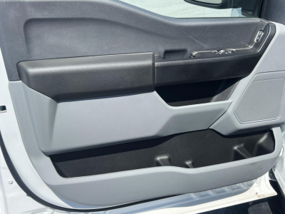 Ford F-450 cab and chassis door interior panel with armrest and storage pocket visible.