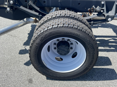 Truck wheel and tire on Ford F-450 cab and chassis showing Continental ContiPro? tire with white steel wheel and hub.